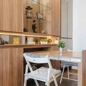 Modern study area with wooden cabinetry and stylish decor in a cozy apartment.