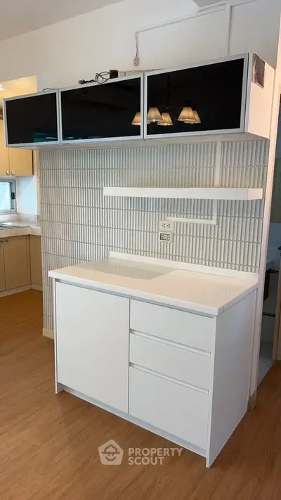 Modern kitchen with sleek cabinetry and open layout in a stylish apartment.