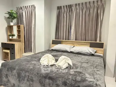 Cozy bedroom with elegant decor and plush bedding, perfect for relaxation.