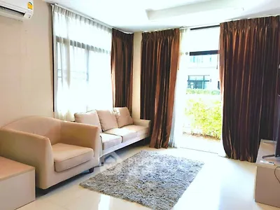 Bright and cozy living room with plush seating and large windows in modern home