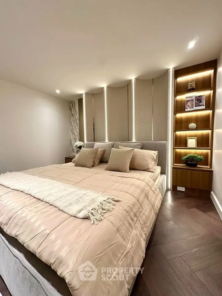 Luxurious bedroom with elegant lighting and plush bedding in modern apartment