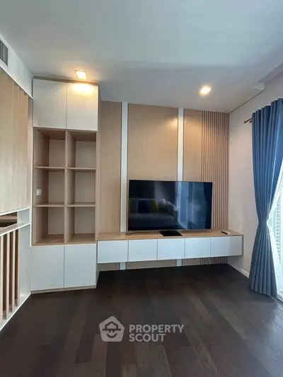 Modern living room with sleek TV unit and elegant wooden flooring