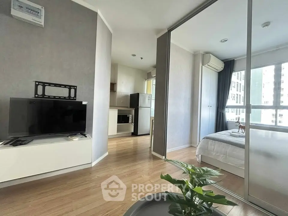 Modern apartment interior with open layout, featuring a cozy living area and sleek kitchen.