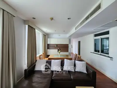 Spacious living room with modern decor and large windows for natural light.