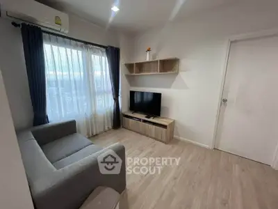 Modern living room with sleek furniture and natural light, perfect for cozy relaxation.
