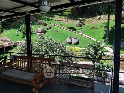 Charming garden view from covered patio with rustic wooden seating