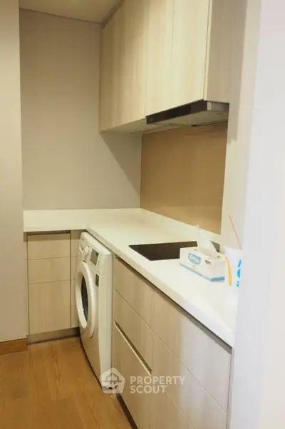 Modern kitchen with sleek cabinetry and built-in washing machine