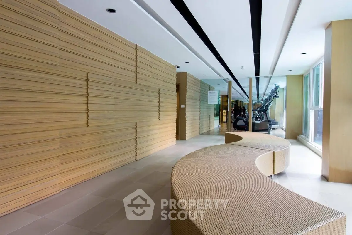 Modern gym interior with stylish seating and fitness equipment