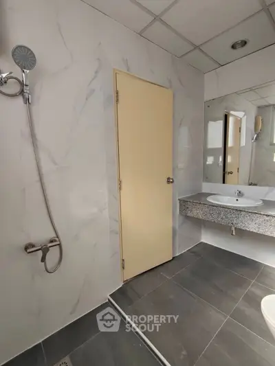 Modern bathroom with sleek shower and elegant marble tiles