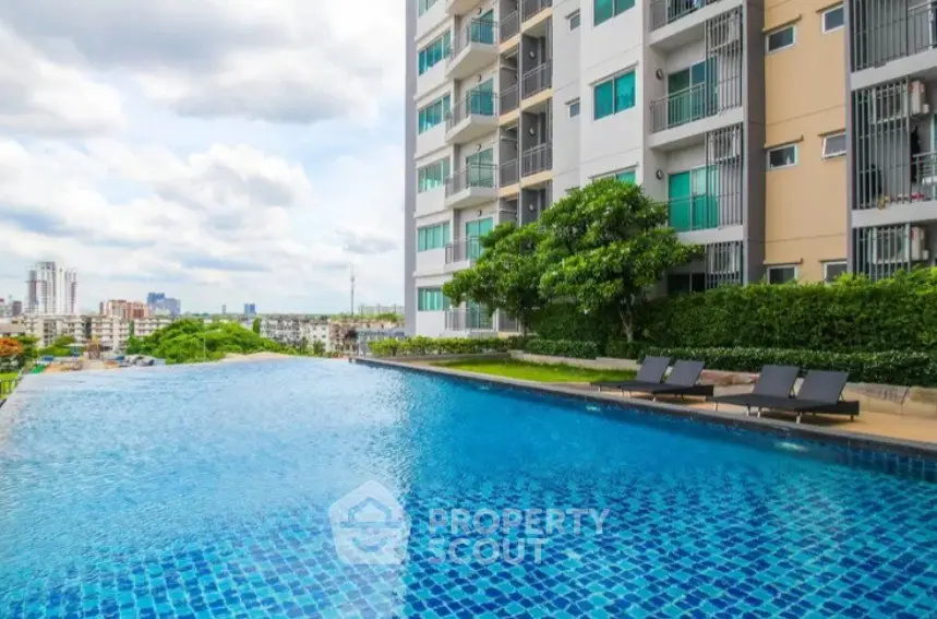 Luxurious apartment building with stunning infinity pool and city view.