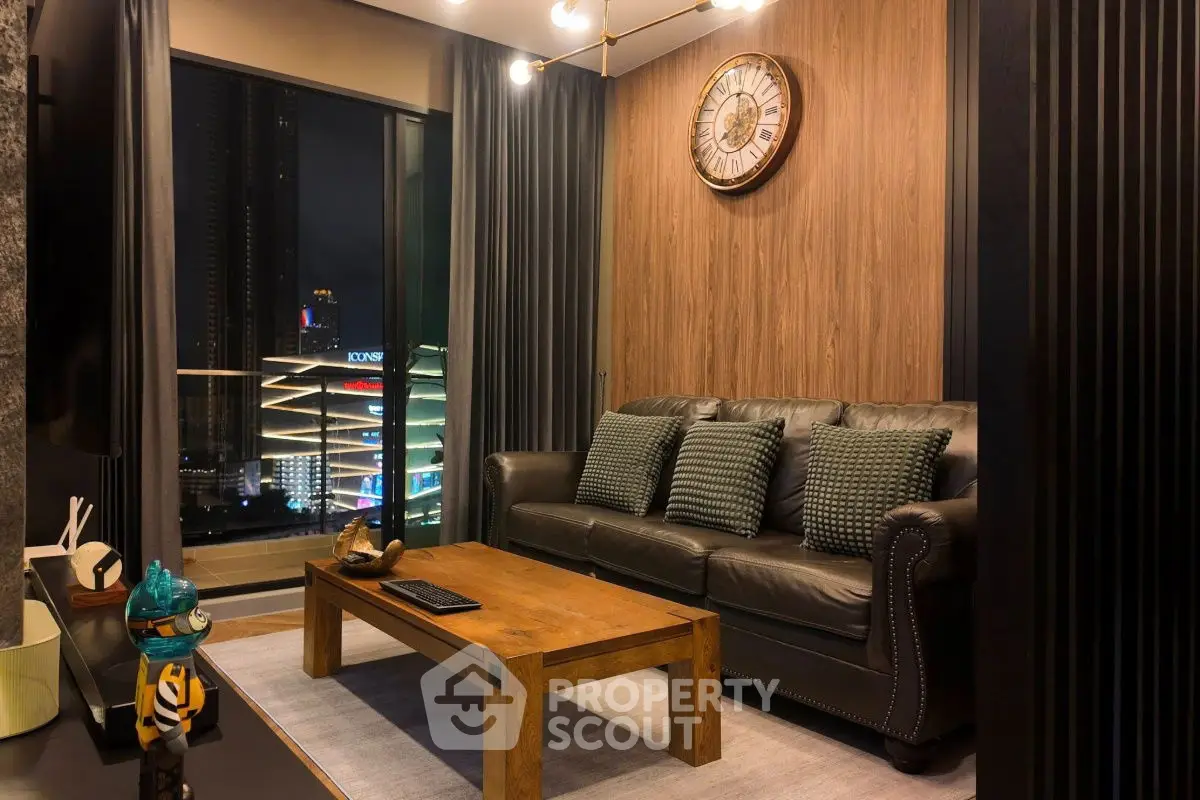Luxurious living room with elegant decor and city view, featuring a stylish leather sofa and wooden accents.