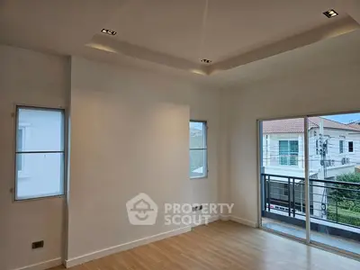 Spacious room with large windows and balcony access in modern home