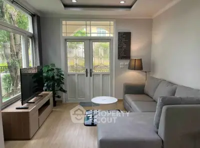 Cozy living room with modern gray sofa and large window view