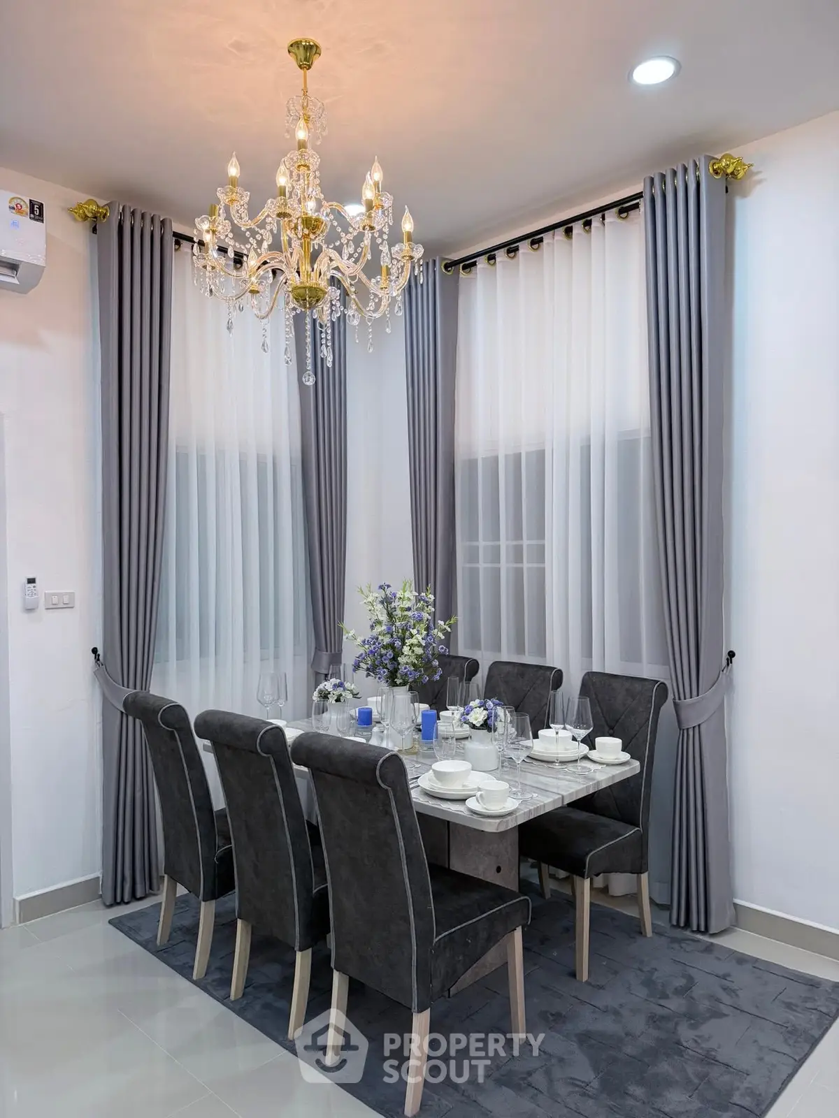Elegant dining room with chandelier and modern decor, perfect for hosting dinner parties.