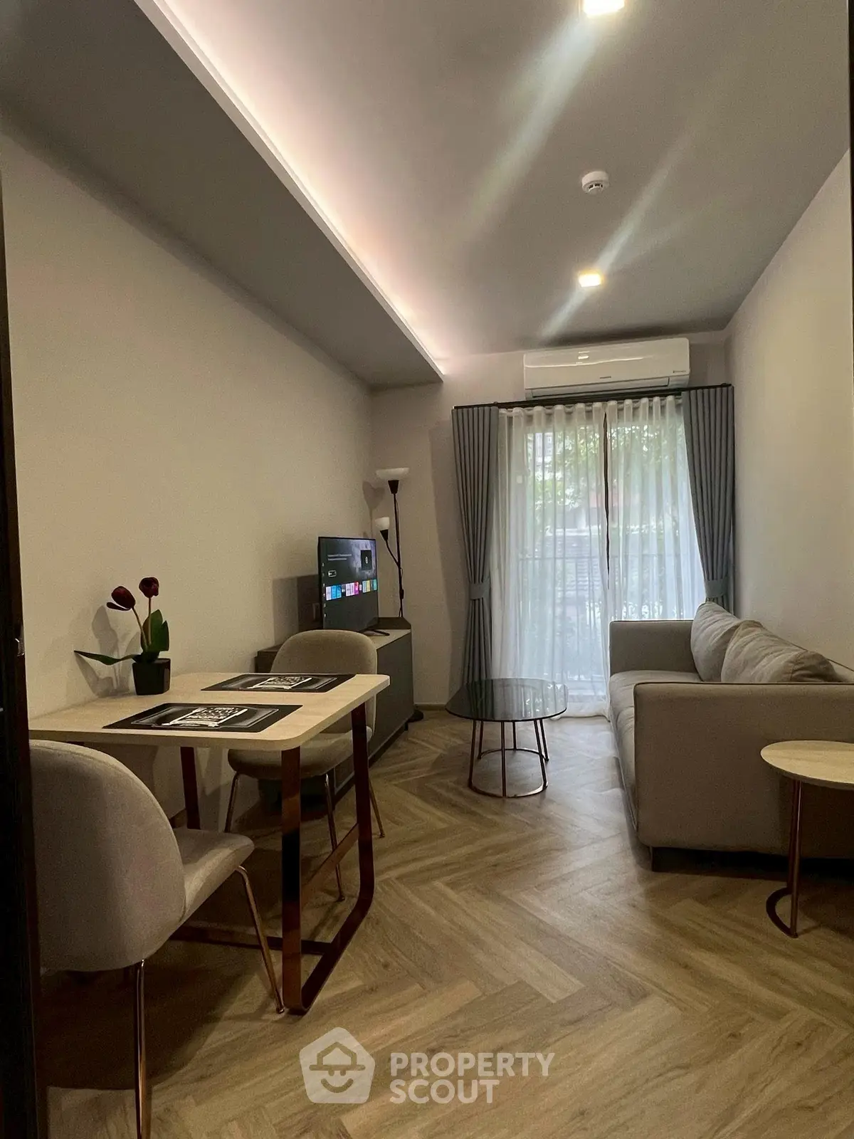 Modern living room with stylish furniture and natural light, perfect for relaxation.