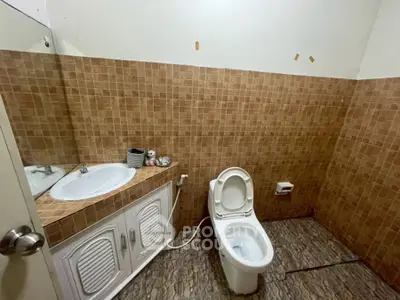 Spacious bathroom with tiled walls and modern fixtures