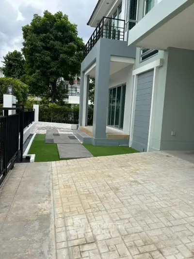 Modern house exterior with paved driveway and landscaped garden