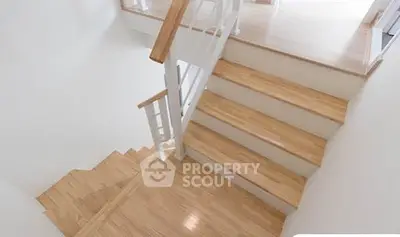 Elegant wooden staircase with modern railing in a bright home interior