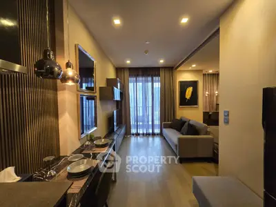 Modern living room with stylish decor and open layout, featuring a cozy sofa and elegant lighting.