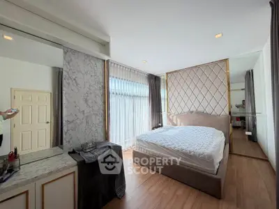 Luxurious bedroom with elegant decor and large window for natural light