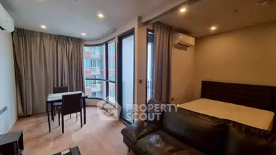 Modern living room with dining area and large windows in a stylish apartment.