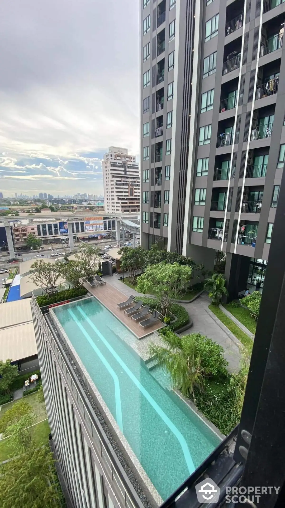 Modern high-rise building with rooftop pool and city view