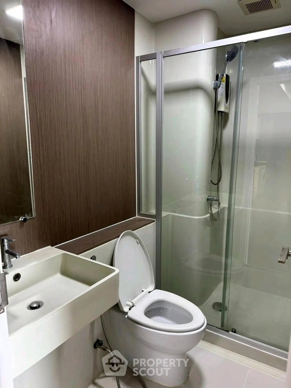 Modern bathroom with sleek shower and contemporary fixtures in a stylish apartment.