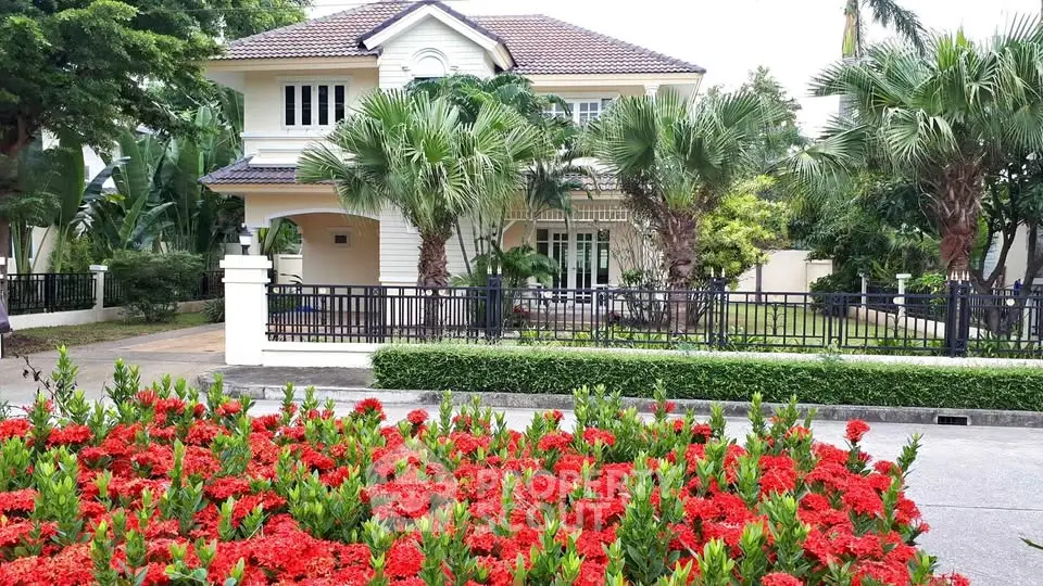 Charming suburban home with lush garden and vibrant red flowers