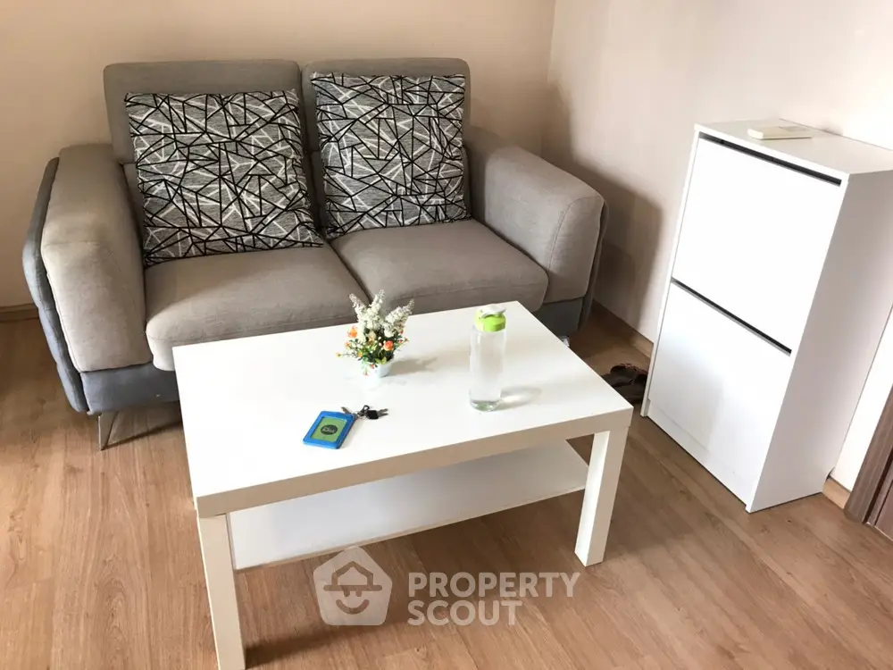Cozy living room with modern sofa and sleek white coffee table in stylish apartment.