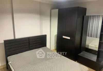 Modern bedroom with sleek black furniture and cozy ambiance