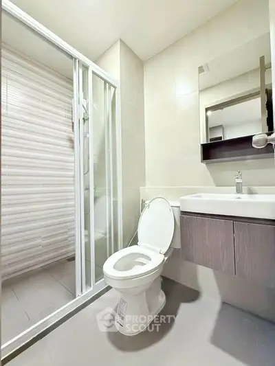 Modern bathroom with sleek shower and contemporary fixtures in a stylish apartment.