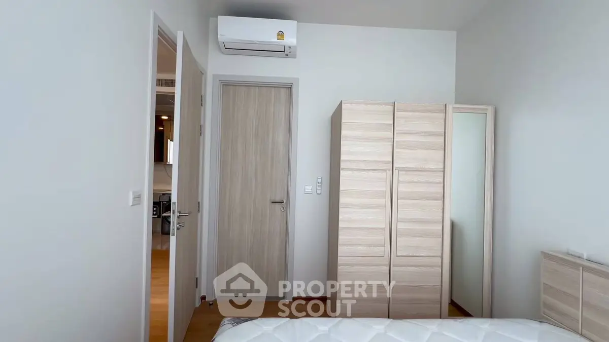 Modern bedroom with sleek wardrobe and air conditioning unit