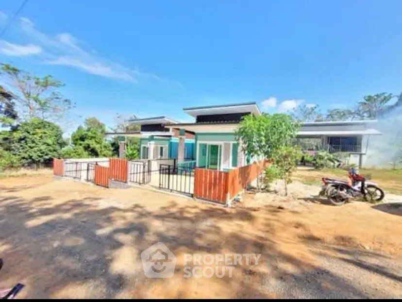 Modern single-story house with spacious driveway and lush greenery