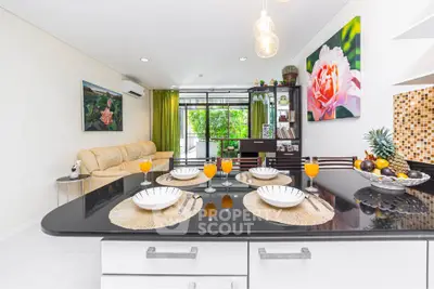 Modern open-layout kitchen with elegant dining setup and vibrant decor