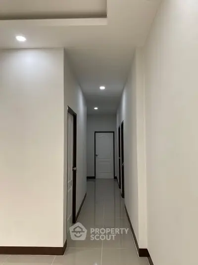 Spacious modern hallway with sleek design and polished floors.