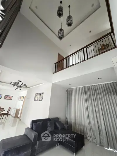 Spacious modern living room with high ceiling and elegant decor