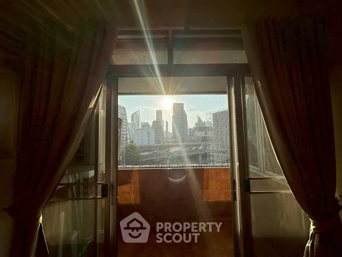 Stunning city view from a cozy balcony at sunset, perfect for urban living.