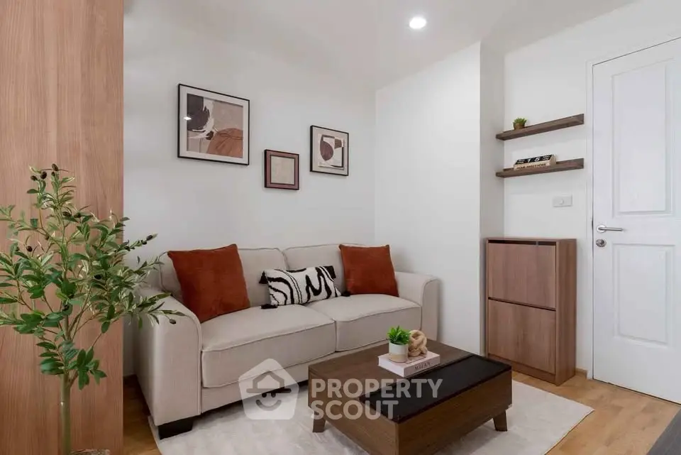 Cozy living room with modern decor, featuring a comfortable sofa, stylish artwork, and elegant wooden furniture.