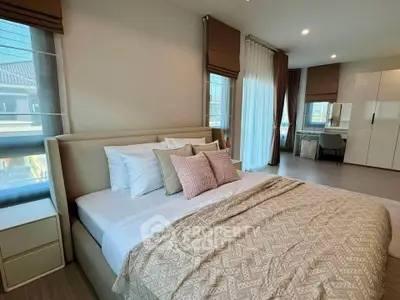 Spacious modern bedroom with elegant decor and natural light