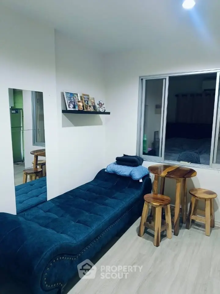 Cozy living room with blue chaise lounge and wooden table set