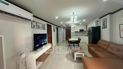 Spacious modern living room with open kitchen, stylish decor, and comfortable seating in a contemporary apartment.
