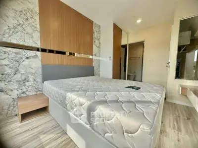 Modern bedroom with stylish decor and natural light, featuring a comfortable bed and elegant design.