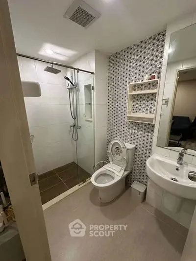 Modern bathroom with glass shower and stylish patterned wall tiles