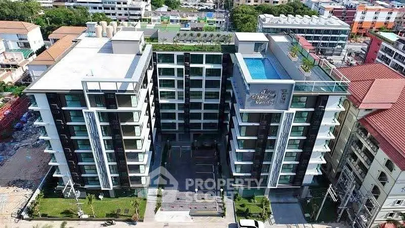 Modern apartment complex with rooftop pool and lush landscaping