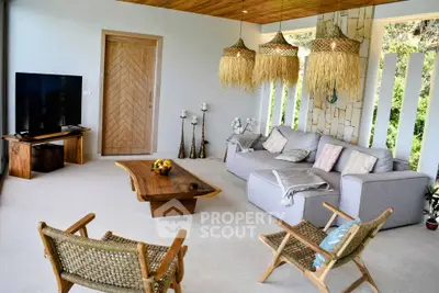 Stylish living room with modern decor and natural light, featuring cozy seating and a flat-screen TV.