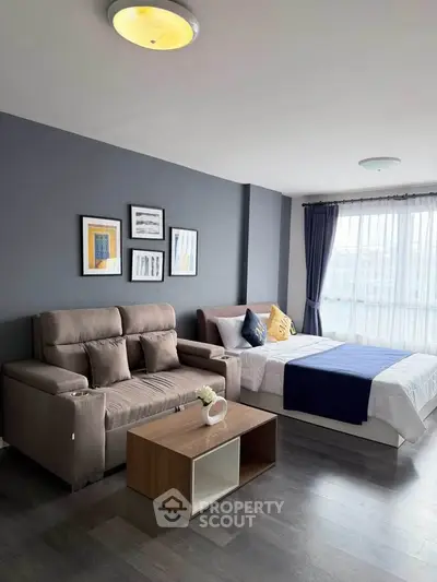 Modern studio apartment with cozy living area and stylish decor