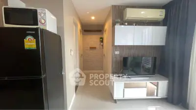 Modern living room with TV, air conditioning, and sleek storage units