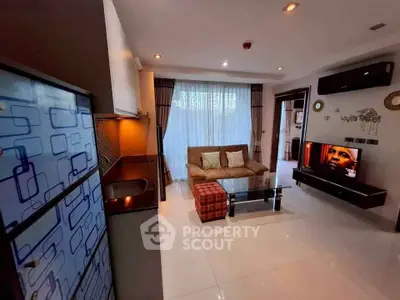 Modern living room with sleek design, featuring a cozy sofa, stylish TV setup, and elegant decor.