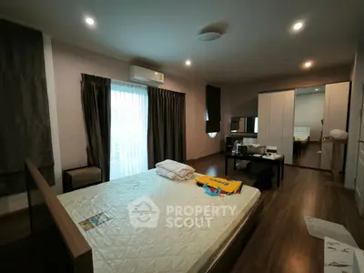 Spacious bedroom with modern decor and ample natural light