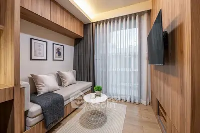Modern living room with cozy sofa, wall-mounted TV, and elegant decor